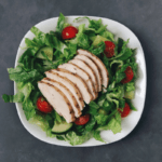 Low FODMAP Seasoned Chicken Breast on garden salad
