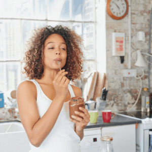 Woman eating out of jar