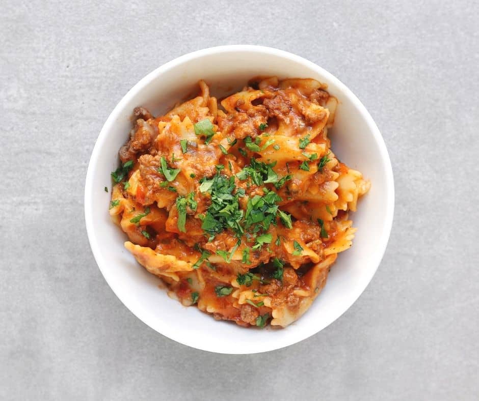 Easy Low FODMAP Lasagna in bowl with fresh parsley - 940 x 788