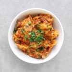 Easy Low FODMAP Lasagna in bowl with fresh parsley - Feature Image