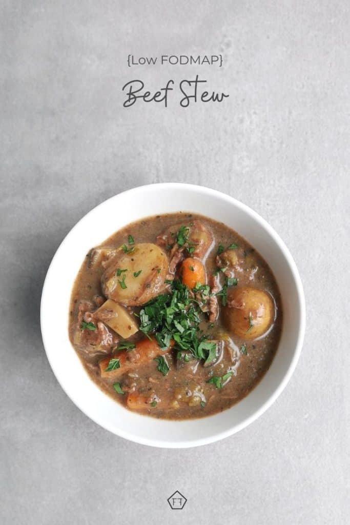 Beef stew in bowl on grey background with text overlay: low FODMAP beef stew