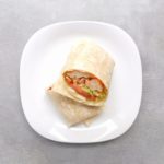 Low FODMAP Buffalo Chicken Wrap on white plate