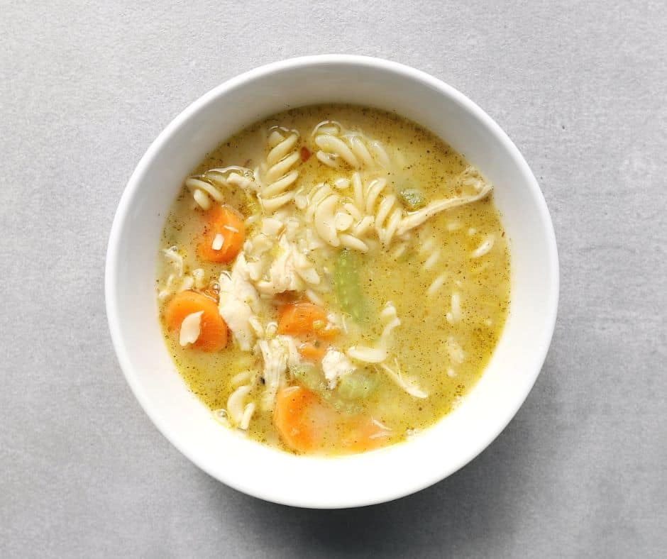 Low FODMAP chicken noodle soup in bowl - 940 x 788