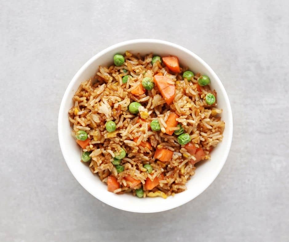 Low FODMAP fried rice with peas and carrots in bowl - 940 x 788