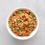 Low FODMAP fried rice with peas and carrots in bowl - Feature Image