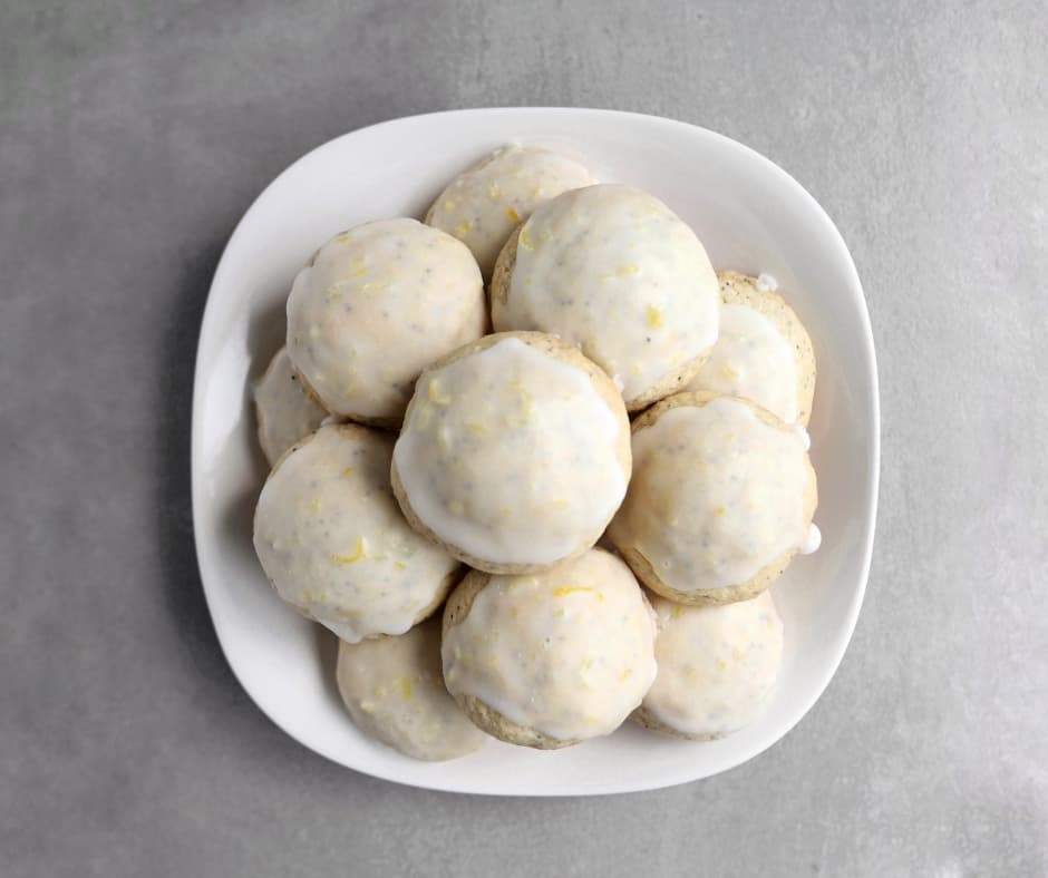 Low FODMAP lemon poppy seed cookies piled on plate - 940 x 788