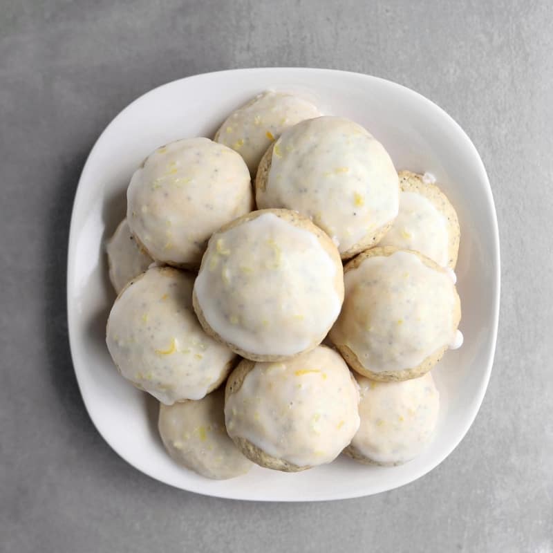 Low FODMAP lemon poppy seed cookies piled on plate - 800 x 800