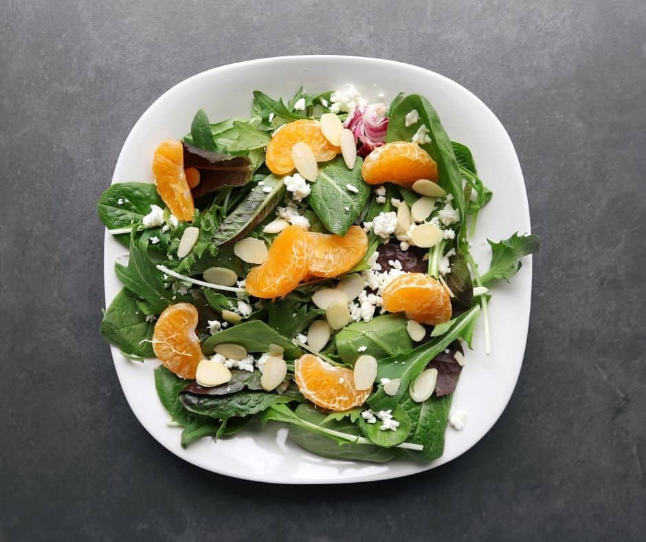 Low FODMAP mandarin orange salad with almonds on plate - 940 x 788