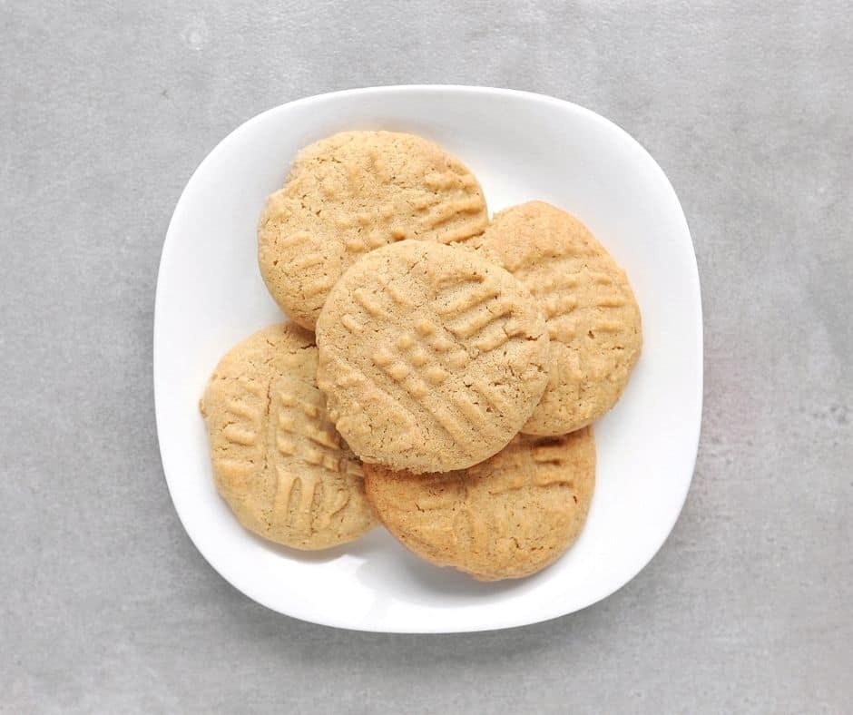 Low FODMAP peanut butter cookies piled on plate - 940 x 788