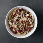 Low FODMAP Pomegranate Quinoa Salad in white bowl on grey surface - 800 x 800