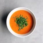 Low FODMAP Roasted Red Pepper Soup in white bowl on grey surface - 800 x 800
