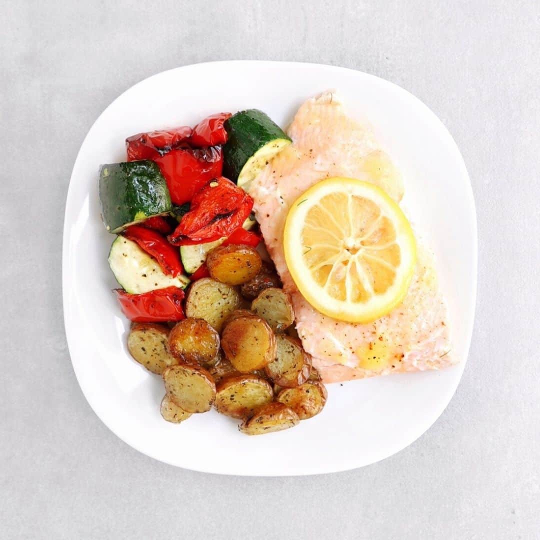 Low FODMAP salmon with roasted lemon, roasted vegetables, and potatoes on plate