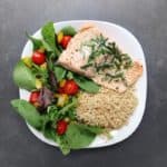 Low FODMAP trout with brown rice and garden salad on plate