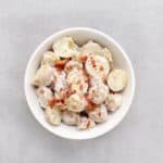Low FODMAP potato salad with bacon bits in bowl