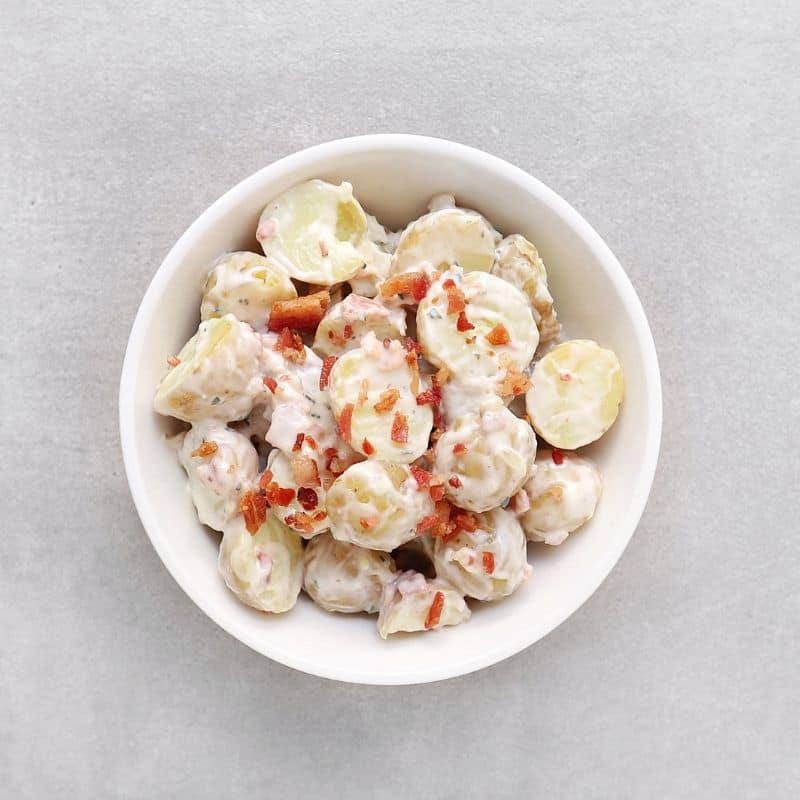 Low FODMAP potato salad with bacon bits in bowl