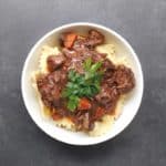 Low FODMAP beef bourguignon in white bowl