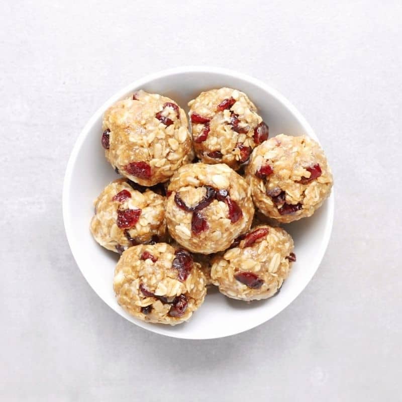 Low FODMAP cranberry white chocolate protein balls in white bowl