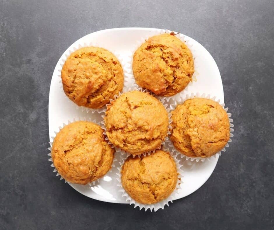 Low FODMAP ginger pumpkin muffins piled on white plate