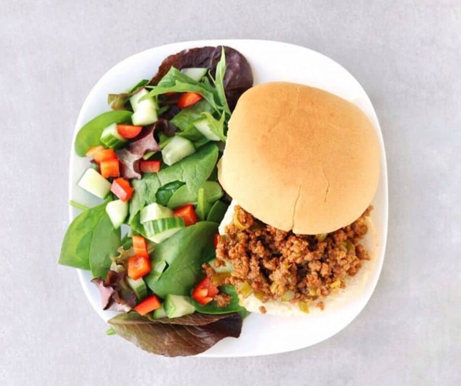 Low FODMAP sloppy Joe on white plate with side salad