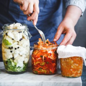 Man packaging fermented food in glass jars