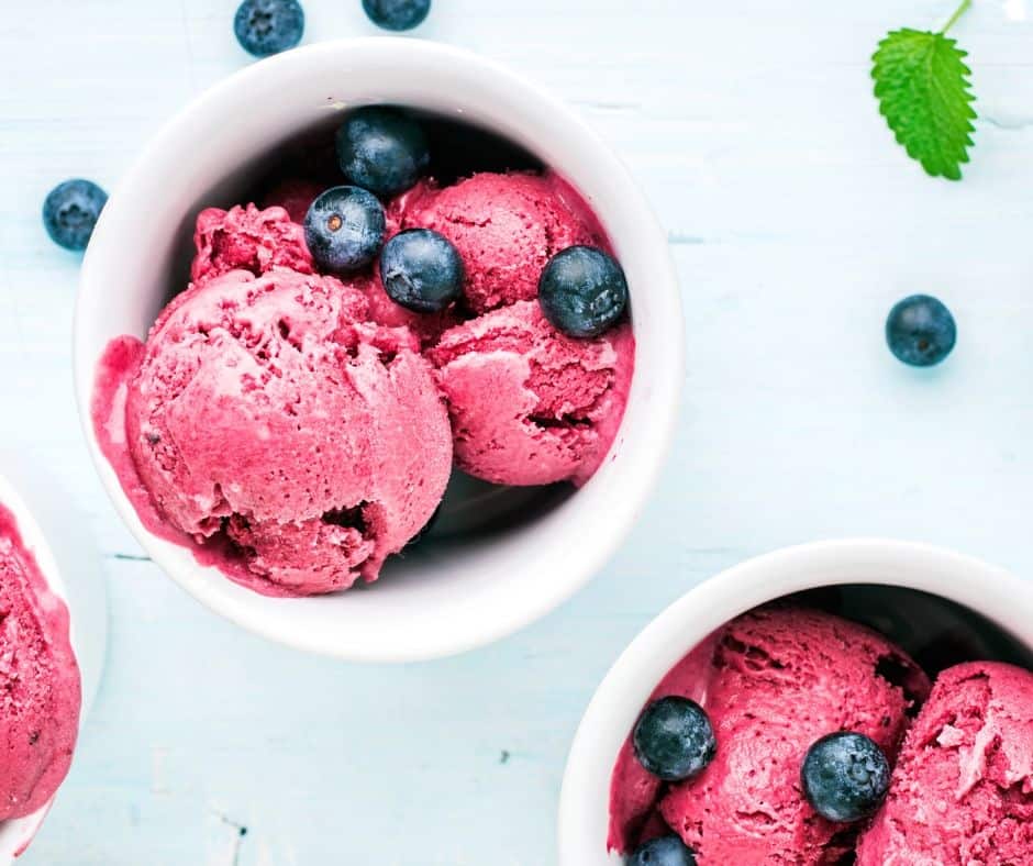 Raspberry ice cream in white bowl